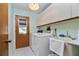 Laundry room with washer, dryer, utility sink, and exterior access at 523 Foxwood Blvd, Englewood, FL 34223