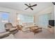 Bright living room with comfy seating, coffee table, and access to sunroom at 523 Foxwood Blvd, Englewood, FL 34223