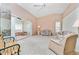 Comfortable living room with floral patterned furniture and a view into another room at 523 Foxwood Blvd, Englewood, FL 34223