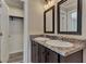 Bathroom boasts double vanity with granite countertop at 1391 Flamingo Dr, Englewood, FL 34224