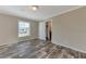 Well-lit bedroom featuring wood-look floors and an ensuite bathroom at 1391 Flamingo Dr, Englewood, FL 34224