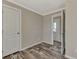 Spacious bedroom with wood-look floors and access to hallway at 1391 Flamingo Dr, Englewood, FL 34224