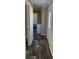 Inviting hallway with wood-look flooring, leading to laundry and bedroom at 1391 Flamingo Dr, Englewood, FL 34224