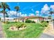 Single-story home with manicured lawn and lush landscaping at 1391 Flamingo Dr, Englewood, FL 34224