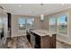 Modern kitchen with large island, stainless steel appliances, and wood cabinets at 1391 Flamingo Dr, Englewood, FL 34224