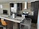 Modern kitchen with dark cabinetry and stainless steel appliances at 1391 Flamingo Dr, Englewood, FL 34224