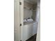 Convenient laundry room with washer and dryer, and overhead shelving at 1391 Flamingo Dr, Englewood, FL 34224