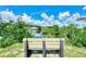 Relaxing park bench overlooking a serene canal with lush foliage at 1391 Flamingo Dr, Englewood, FL 34224