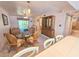 Living room with glass dining table and access to patio at 179 Boundary Blvd # 7, Rotonda West, FL 33947