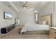 Spacious bedroom with large bed, TV, and plenty of natural light at 20450 Revival Ln, Venice, FL 34293