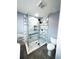 Modern bathroom with frameless shower and marble at 1019 Schooner Ln, Englewood, FL 34224