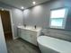 Bathroom with double vanity and free standing tub at 1019 Schooner Ln, Englewood, FL 34224