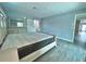 Light and airy bedroom with large bed and access to bathroom at 1019 Schooner Ln, Englewood, FL 34224