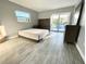 Bright bedroom with pool view, large bed, and ample closet space at 1019 Schooner Ln, Englewood, FL 34224