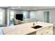 Modern kitchen island with white cabinets and quartz countertop at 1019 Schooner Ln, Englewood, FL 34224