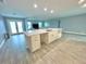 Modern kitchen with island and view into living room at 1019 Schooner Ln, Englewood, FL 34224