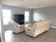 Spacious living room featuring comfortable seating and large TV at 1019 Schooner Ln, Englewood, FL 34224