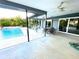 Relaxing pool area with patio furniture and covered lanai at 1019 Schooner Ln, Englewood, FL 34224