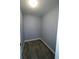 Empty storage room with gray walls and wood floor at 1019 Schooner Ln, Englewood, FL 34224