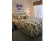 Comfortable bedroom featuring a queen-size bed with tropical-themed bedding at 15001 Appleton Blvd, Port Charlotte, FL 33981