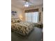Inviting bedroom with tropical bedding, soft lighting, and a ceiling fan at 15001 Appleton Blvd, Port Charlotte, FL 33981