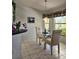 Cozy breakfast nook with a glass-top table, chairs, and natural light from the large window at 15001 Appleton Blvd, Port Charlotte, FL 33981