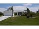 Well-maintained single-story home featuring a lush lawn and charming front entryway at 15001 Appleton Blvd, Port Charlotte, FL 33981