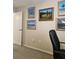 Hallway showcasing coastal themed artwork and neutral-colored walls at 15001 Appleton Blvd, Port Charlotte, FL 33981