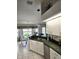 Bright kitchen featuring white cabinets, stainless steel appliances, and a view of the adjacent breakfast nook at 15001 Appleton Blvd, Port Charlotte, FL 33981