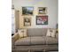 Comfortable living room with sofa, pillows, file cabinet, and artwork at 15001 Appleton Blvd, Port Charlotte, FL 33981