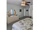 Bright main bedroom featuring soft colors, a ceiling fan, and access to other rooms, creating a comfortable and inviting space at 15001 Appleton Blvd, Port Charlotte, FL 33981