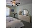 Bedroom featuring a dresser with a mirror, soft lighting, and ample space for relaxation and storage at 15001 Appleton Blvd, Port Charlotte, FL 33981