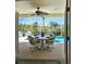 Screened-in patio with dining table and chairs, overlooking the pool area at 15001 Appleton Blvd, Port Charlotte, FL 33981