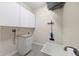 Laundry room with cabinets and utility sink at 520 Liberty St, Englewood, FL 34223