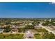 An aerial view showcasing a neighborhood with houses, roads, and waterways at 9660 Miami Cir, Port Charlotte, FL 33981