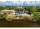 Aerial view of a house with a pool and private dock on a canal at 9660 Miami Cir, Port Charlotte, FL 33981