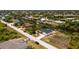 Aerial view of a canal-front home with a neighborhood in the background at 9660 Miami Cir, Port Charlotte, FL 33981