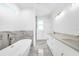 Elegant bathroom featuring a freestanding tub and dual vanities with marble accents at 147 Ingram Rd, Rotonda West, FL 33947