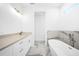 Modern bathroom with white cabinets, a freestanding tub, and marble tile at 147 Ingram Rd, Rotonda West, FL 33947