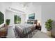 Main bedroom with sliding glass doors, plush bed, and ample natural light at 147 Ingram Rd, Rotonda West, FL 33947