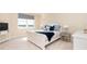 Bright bedroom with a queen-size bed and water views at 10309 Coral Landings Ct # 101, Placida, FL 33946