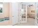 Open living room with French doors and cozy seating area at 10309 Coral Landings Ct # 101, Placida, FL 33946