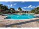 Community pool with lounge chairs at 10309 Coral Landings Ct # 101, Placida, FL 33946