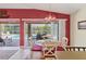 The dining area has red accents and a large sliding glass door that looks out onto the screened patio and pool at 163 Jennifer Dr, Rotonda West, FL 33947