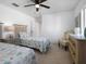 Bedroom with two twin beds, dresser, and ceiling fan at 256 Mariner Ln, Rotonda West, FL 33947