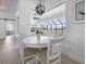 Casual dining area with white table and chairs, and view to backyard at 256 Mariner Ln, Rotonda West, FL 33947