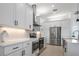 Kitchen with stainless steel appliances and white cabinets at 256 Mariner Ln, Rotonda West, FL 33947