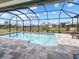 Screened-in pool with surrounding patio at 256 Mariner Ln, Rotonda West, FL 33947