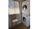 Bright laundry room features a washer and dryer, and a window with curtains at 2051 Mississippi Ave, Englewood, FL 34224