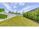 Landscaped backyard with a grassy area and privacy fence at 10721 Ayear Rd, Port Charlotte, FL 33981